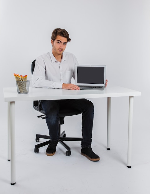 Businessman posing with laptop