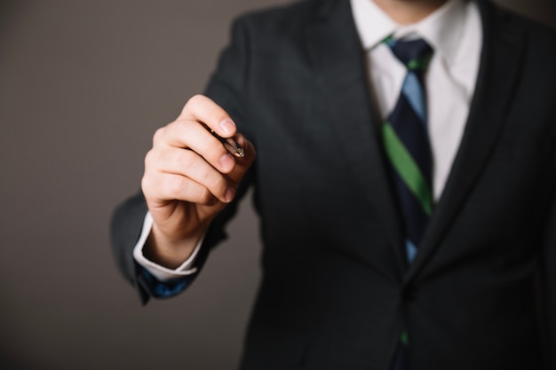 Free photo businessman posing with pen