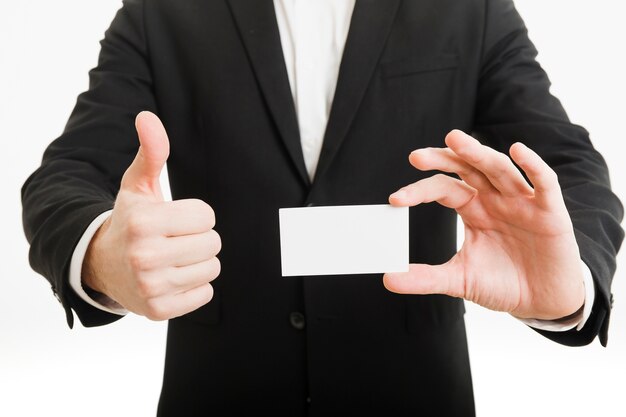 Businessman presenting business card and doing thumbs up gesture