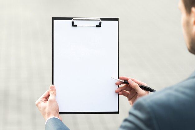 Businessman presenting clipboard