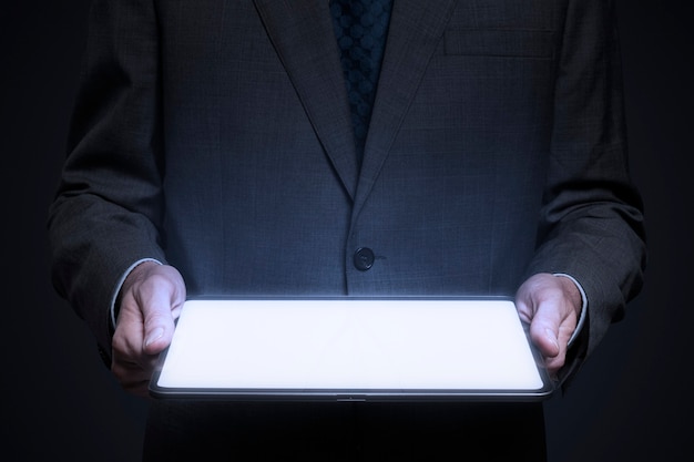 Businessman presenting invisible hologram projecting from tablet advanced technology