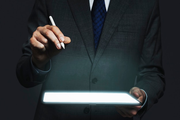 Businessman presenting invisible hologram projecting from tablet advanced technology