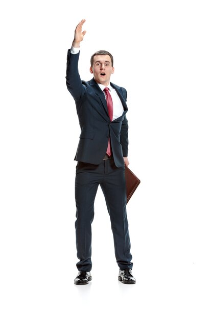 businessman raising his hand on white studio background. Serious young man in suit. Business, career concept.