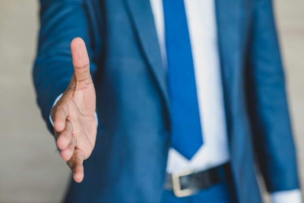 Businessman reaching out his hand