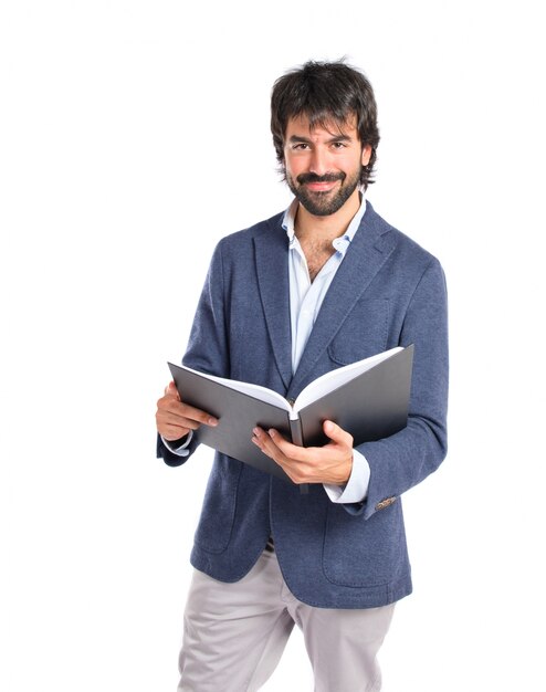 Businessman reading a book over white background