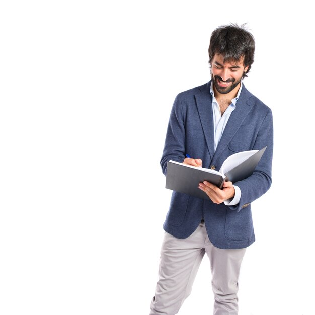 Businessman reading a book over white background