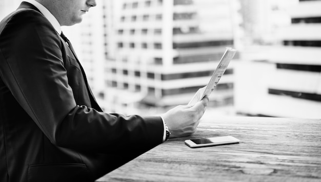 Free photo businessman reading the news