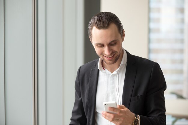 businessman reading and sending messages on phone