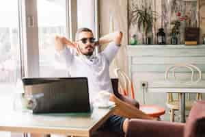 Free photo businessman resting at laptop