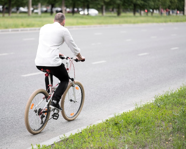 Businessman riding bicycle on the street