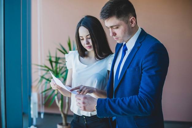 Businessman and secretary checking a document