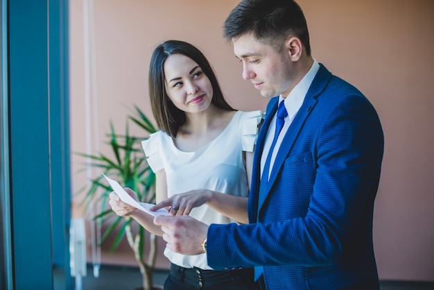 businessman and secretary with a paper