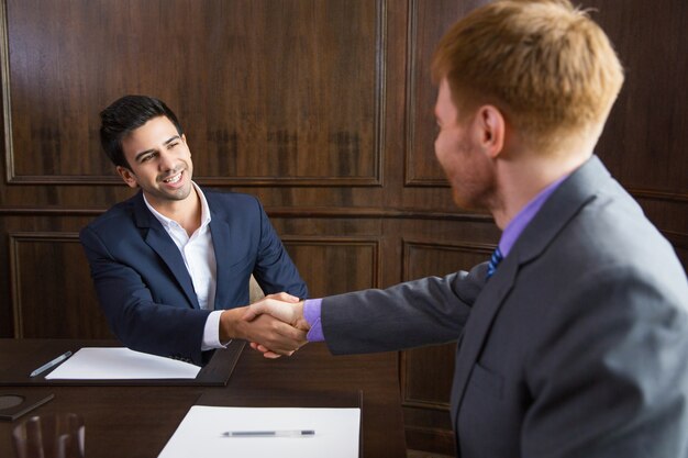 Businessman shaking hands with another man