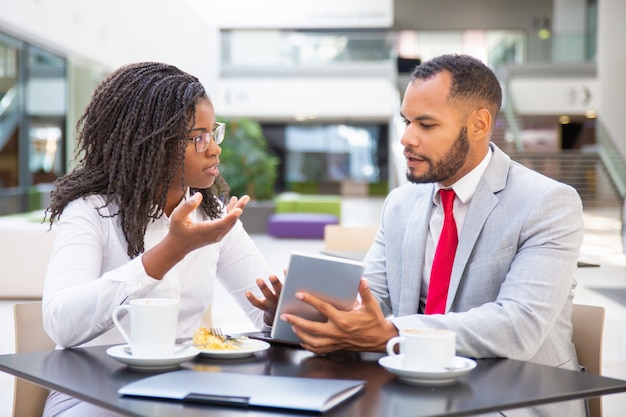 Businessman showing project presentation to female colleague