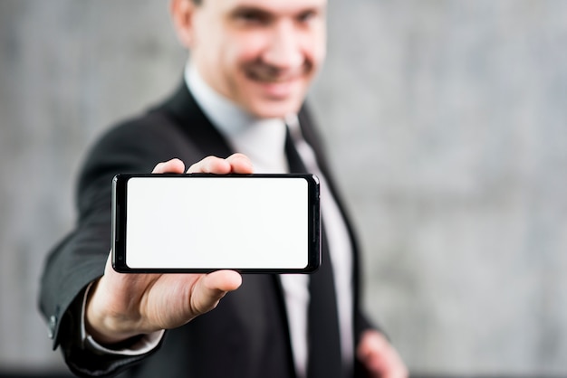 Businessman showing smartphone with clear display