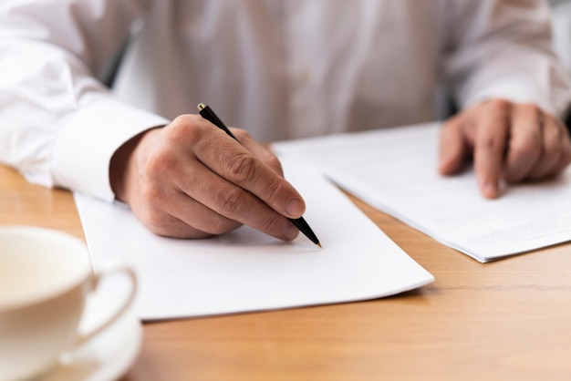 Businessman signing papers at the office