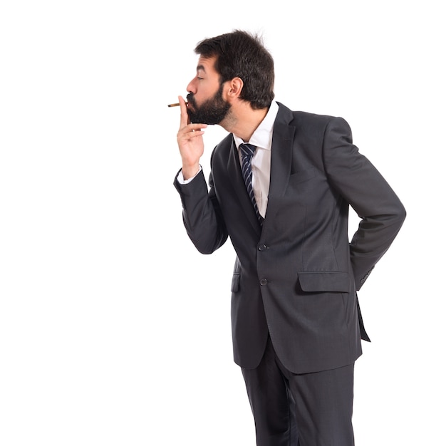 Businessman smoking over isolated white background