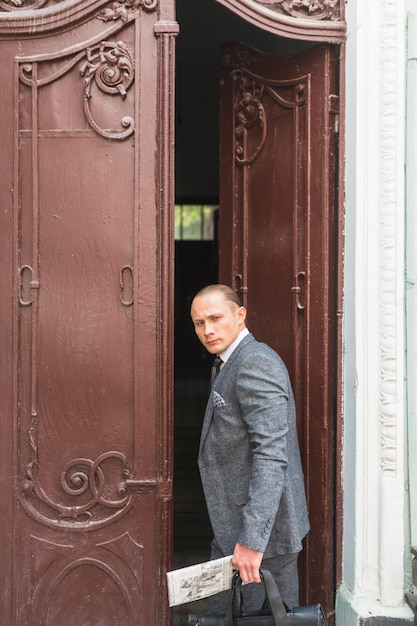 Free photo businessman standing at door