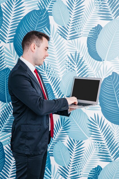 Businessman standing and using laptop