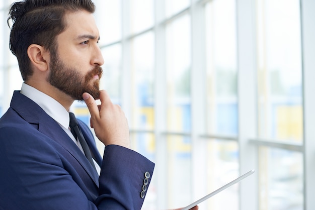 Free photo businessman staring through the window close-up