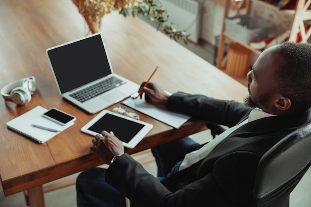 Businessman or student working from home while being isolated or keep quarantine of coronavirus covid-19