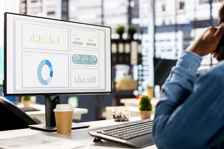 Free Photo businessman studying infographics and performance metrics