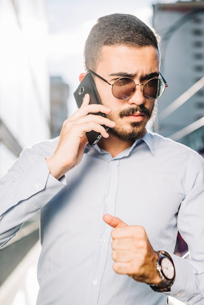 Businessman in sunglasses with phone