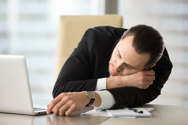 Businessman takes break and dozing in office