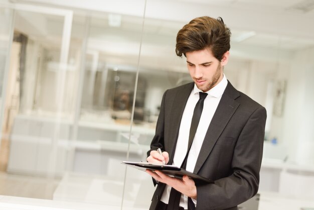 Businessman taking notes on a clipboard