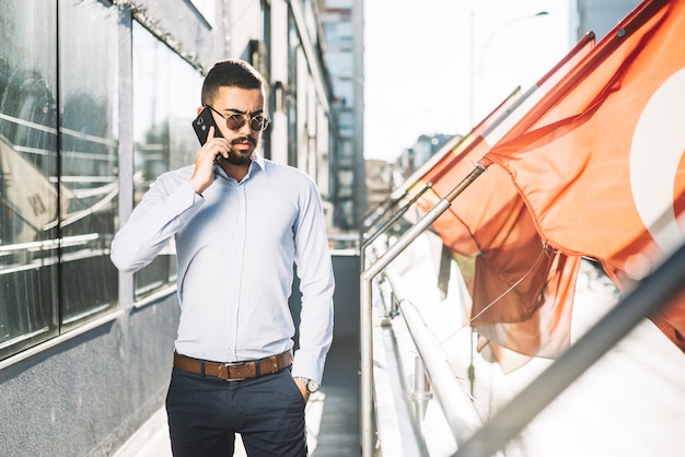 Businessman talking phone at flags