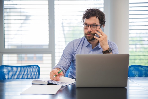 Businessman talking phone in office