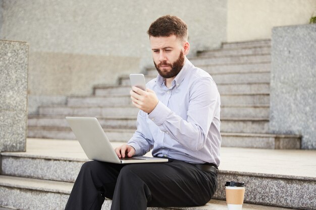 Businessman texting colleague