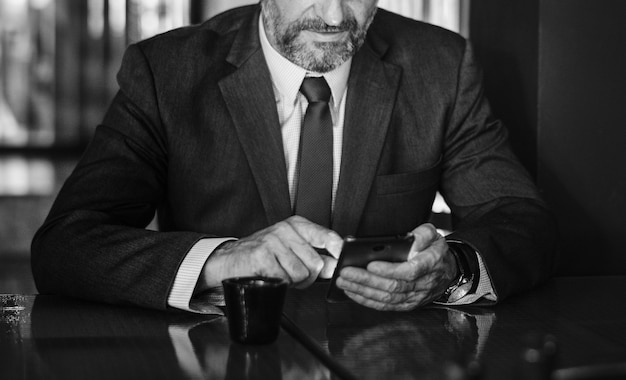 Businessman texting on his mobile phone