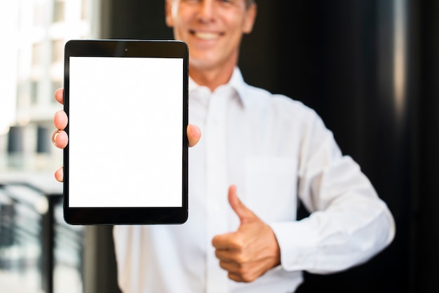 Free photo businessman thumbs up holding tablet mock-up