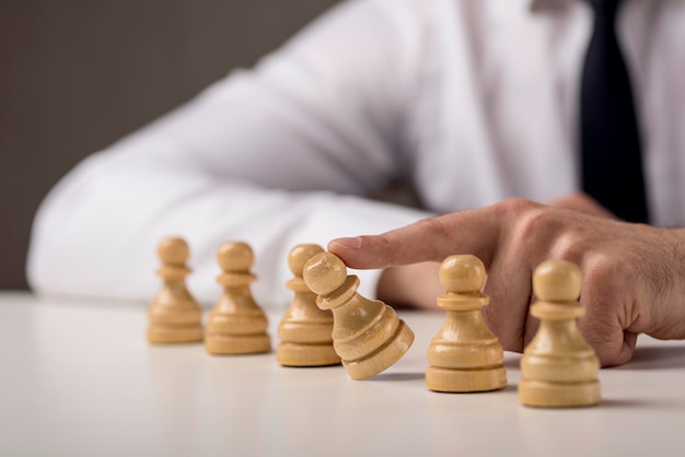 Businessman tumbling a pawn