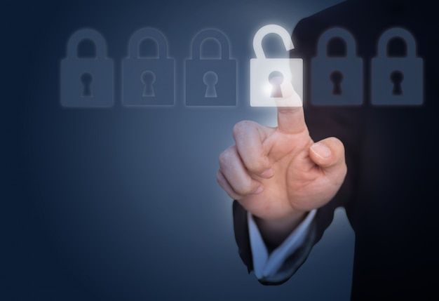 Free photo businessman unlocking a lock on the touch screen