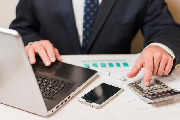 Businessman using calculator