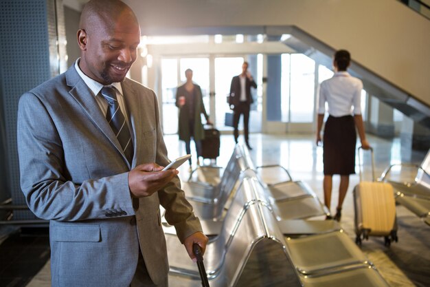 Businessman using mobile phone in waiting area