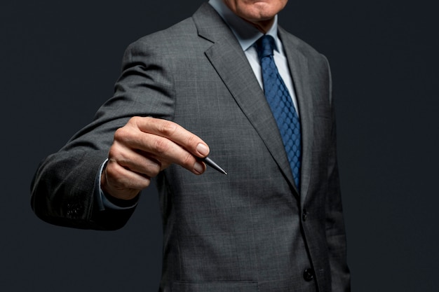 Businessman using a pen and signing on an invisible screen