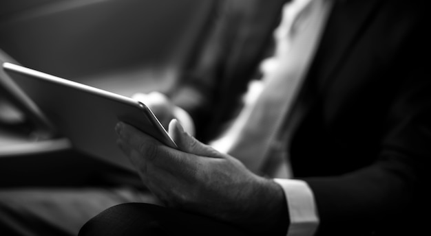 Businessman Using Tablet Working Car Inside