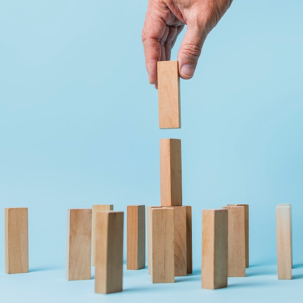 Businessman using wooden pieces 