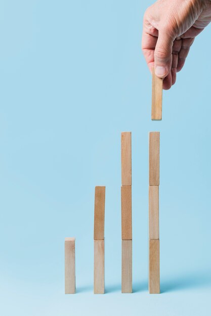 Businessman using wooden pieces 