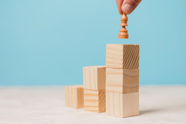 Businessman using wooden pieces 