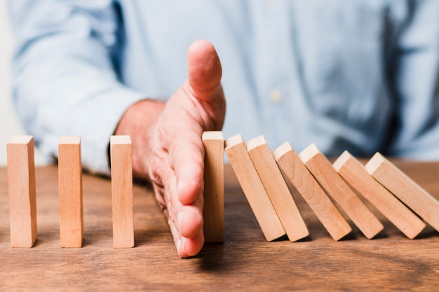 Businessman using wooden pieces 