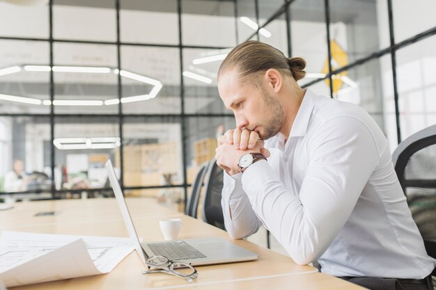 Businessman waiting in front of laptop