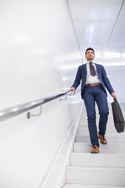 Businessman walking down steps