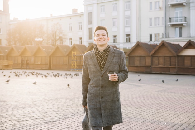 Businessman walking with coffee