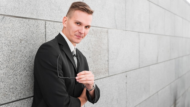 Free photo businessman next to wall