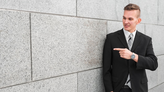 Businessman next to wall