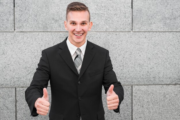 Businessman next to wall